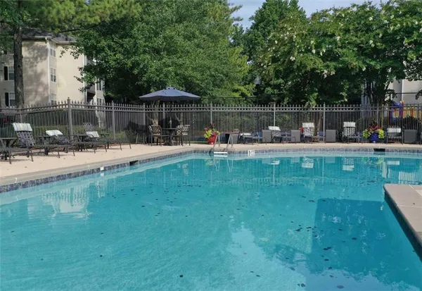 a view of backyard with outdoor seating and green space