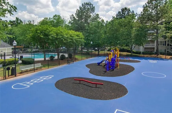 a swimming pool with some trees in the background