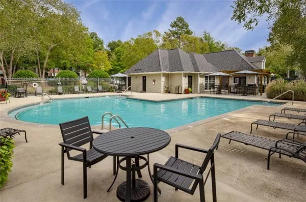 a view of a house with swimming pool and sitting area