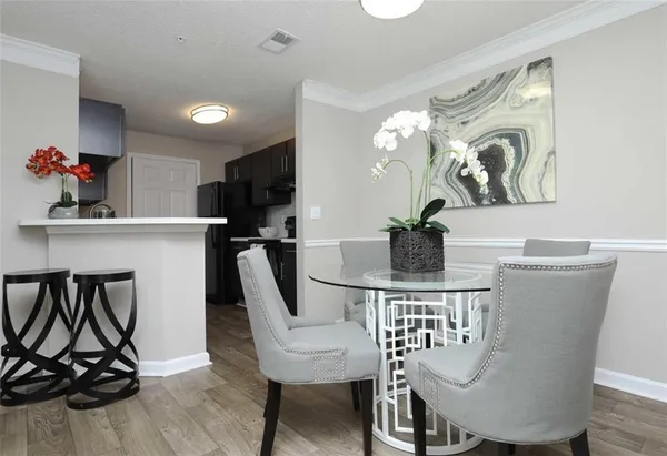 a view of a dining room with furniture and a potted plant