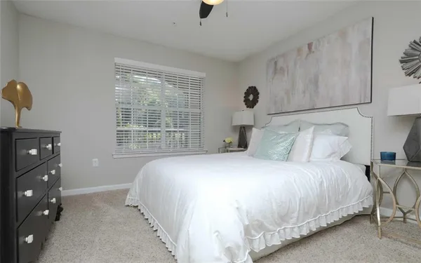 a bedroom with a bed and a night stand