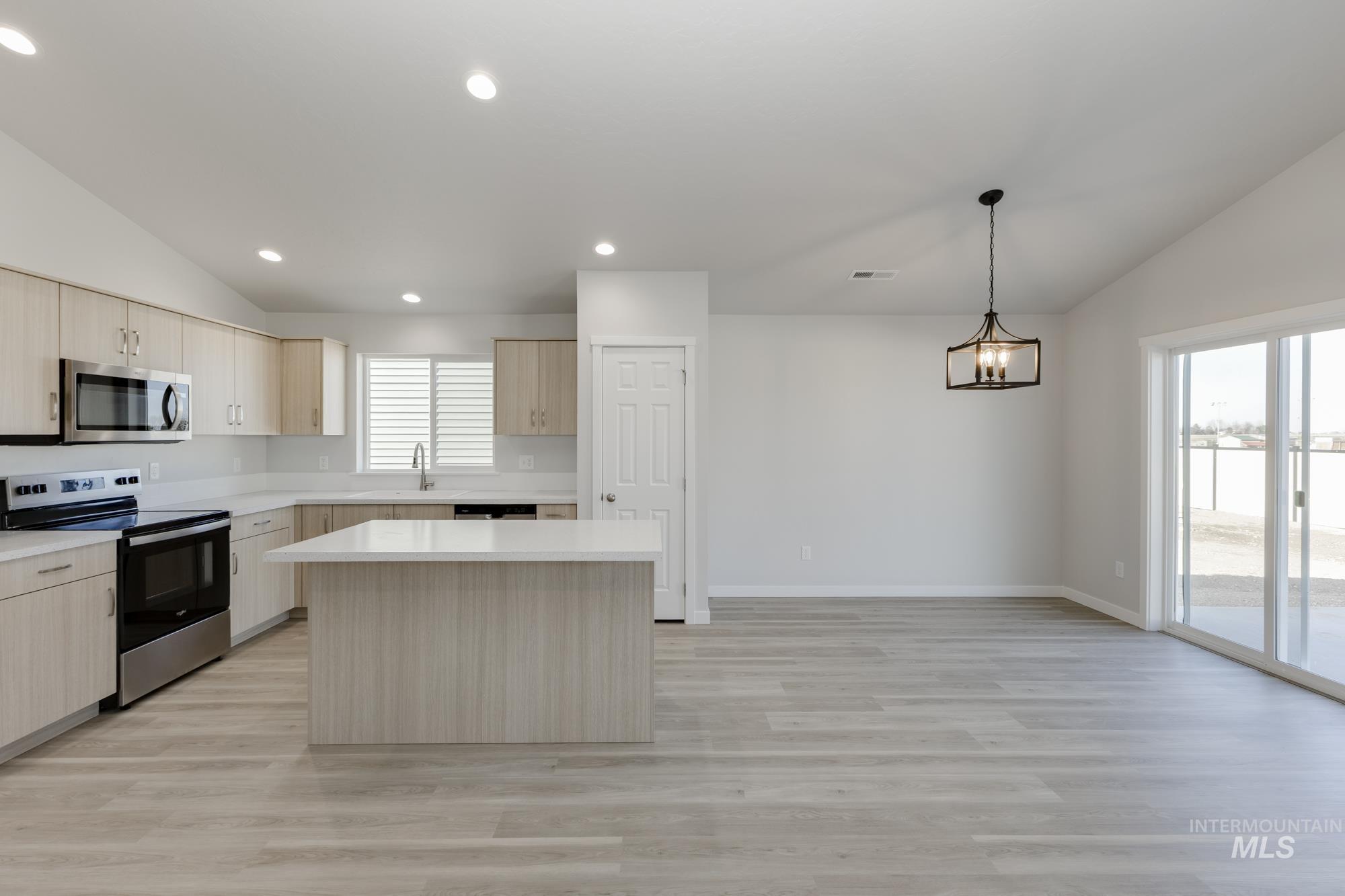 13337 Scrape Street Caldwell, ID 83607 - Photo 6 of 19 Spacious kitchen and dining area featuring wood-finish flooring, vaulted ceilings, and recessed lighting