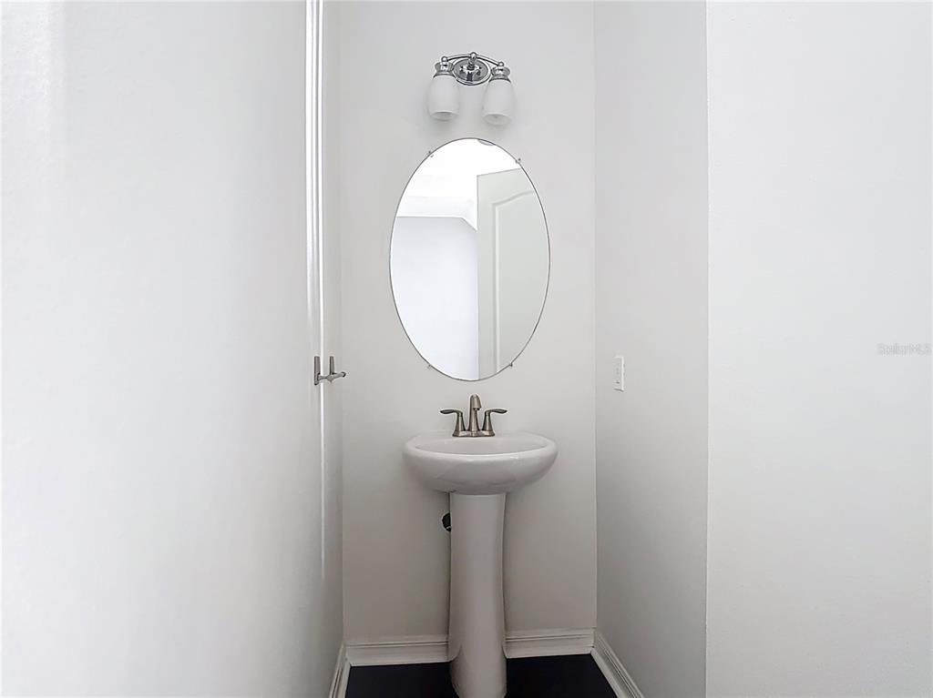 1513 Resolute Street Celebration, FL 34747 - Photo 18 of 43 a bathroom with a sink and a mirror