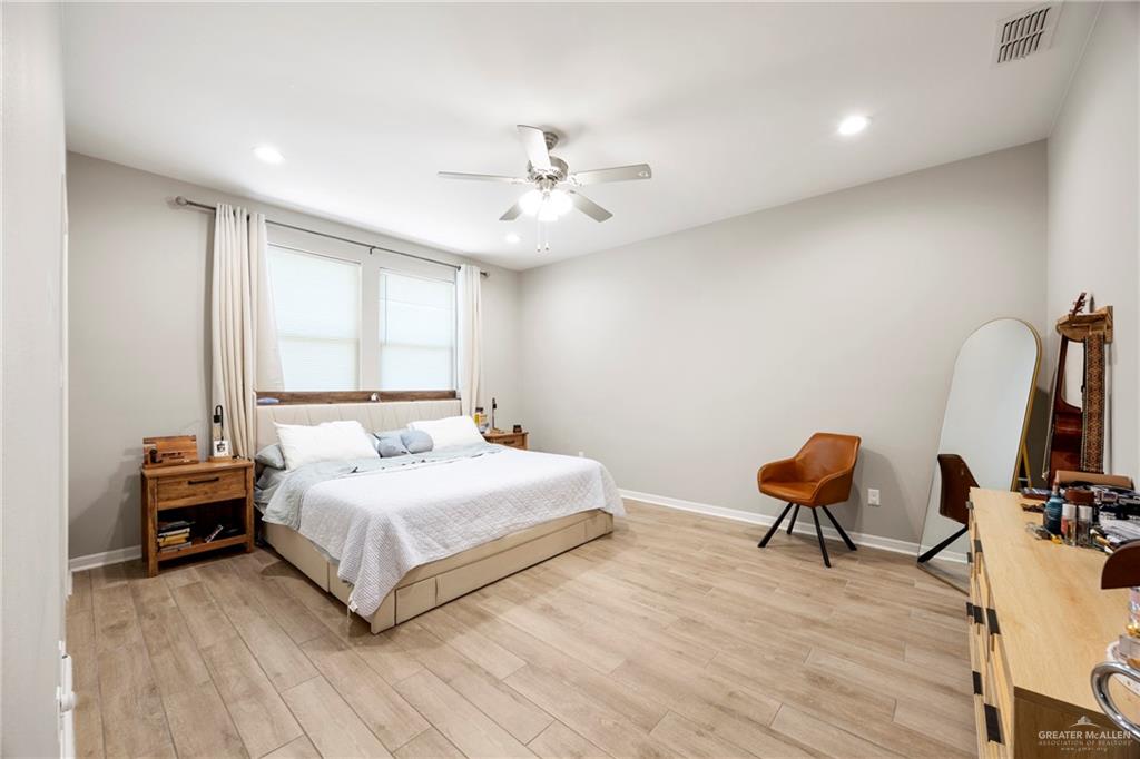 6332 Cascada Bnd Road McAllen, TX 78504 - Photo 5 of 18 a bedroom with a bed and a chair