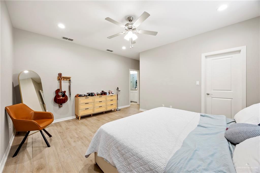 6332 Cascada Bnd Road McAllen, TX 78504 - Photo 6 of 18 a bedroom with a bed and a chair