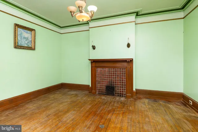 a view of empty room with a fan and a window