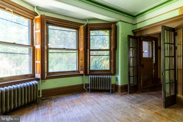 a view of a room with window and wooden floor