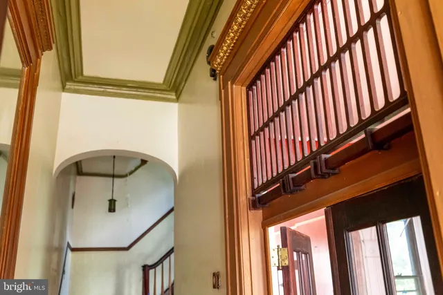 a view of staircase with railing and a rug