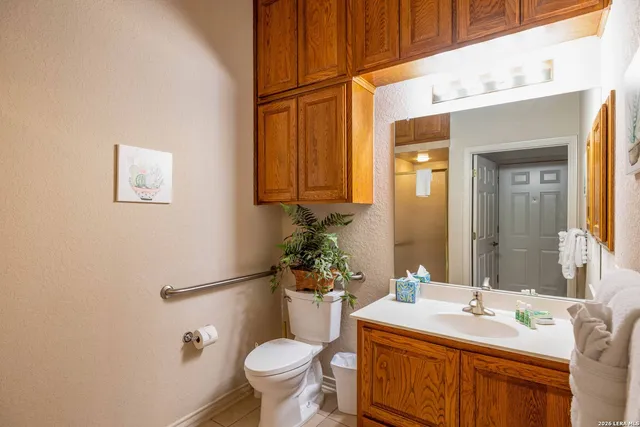 a bathroom with a sink mirror vanity and toilet