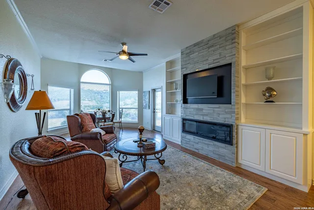 a living room with furniture a fireplace and a flat screen tv