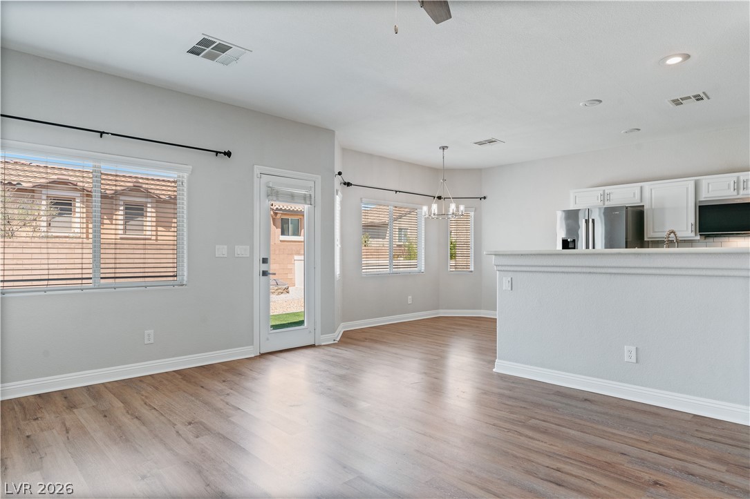 1328 Spice Ridge Court Henderson, NV 89012 - Photo 8 of 51 This bright living space features wood flooring and an inviting open concept connecting to the kitchen.