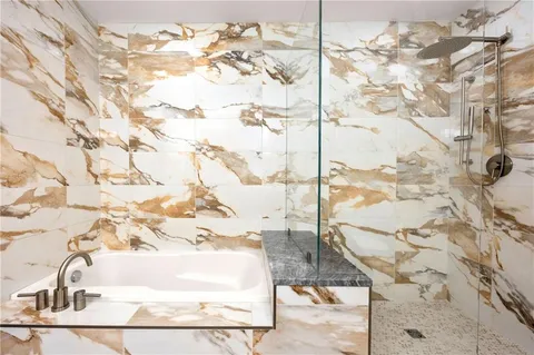 a bathroom with a granite countertop sink a toilet and a mirror