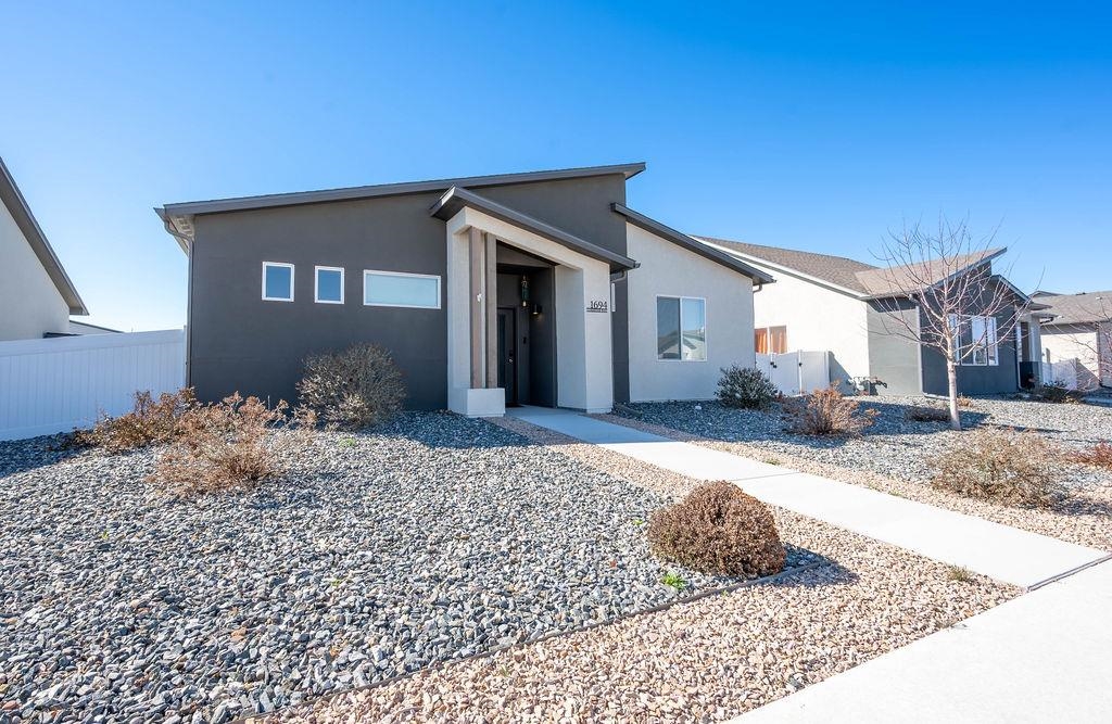 1694 Tungsten Way Fruita, CO 81521 - Photo 2 of 22 a front view of a house with a yard
