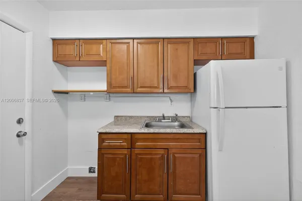 a kitchen with stainless steel appliances granite countertop a refrigerator sink and cabinets