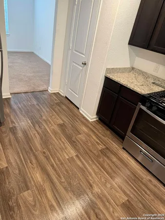 a view of a hardwood floor in an empty room