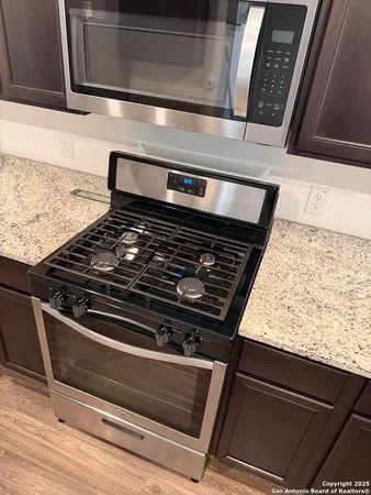 a stove top oven sitting inside of a kitchen