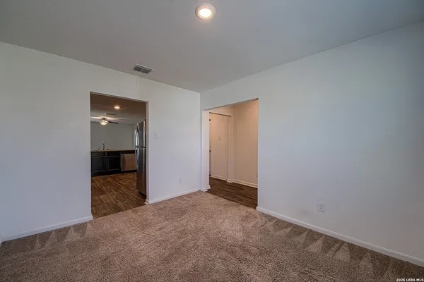 an empty room with closet and bathroom