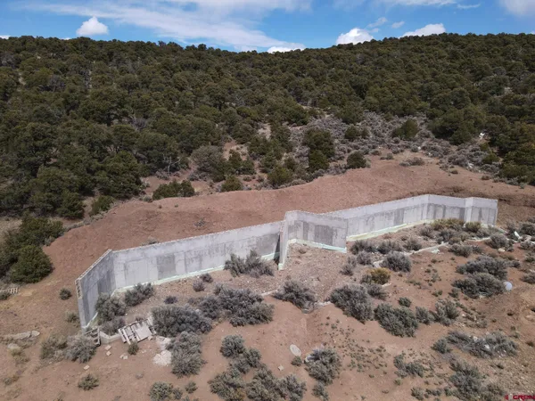a view of a field with a mountain in the background