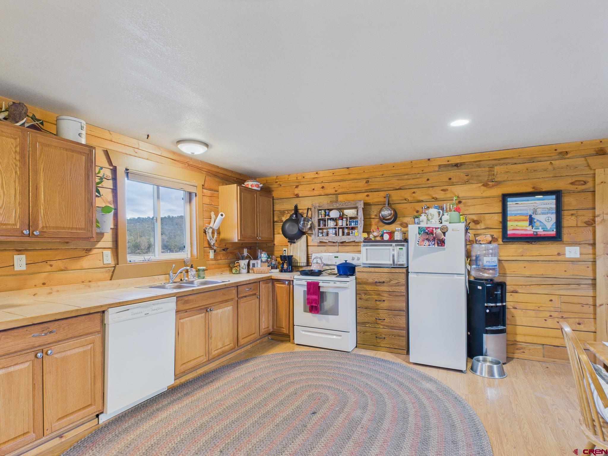 37569 Fruitland Mesa Road Crawford, CO 81415 - Photo 20 of 34 a kitchen with a sink and cabinets