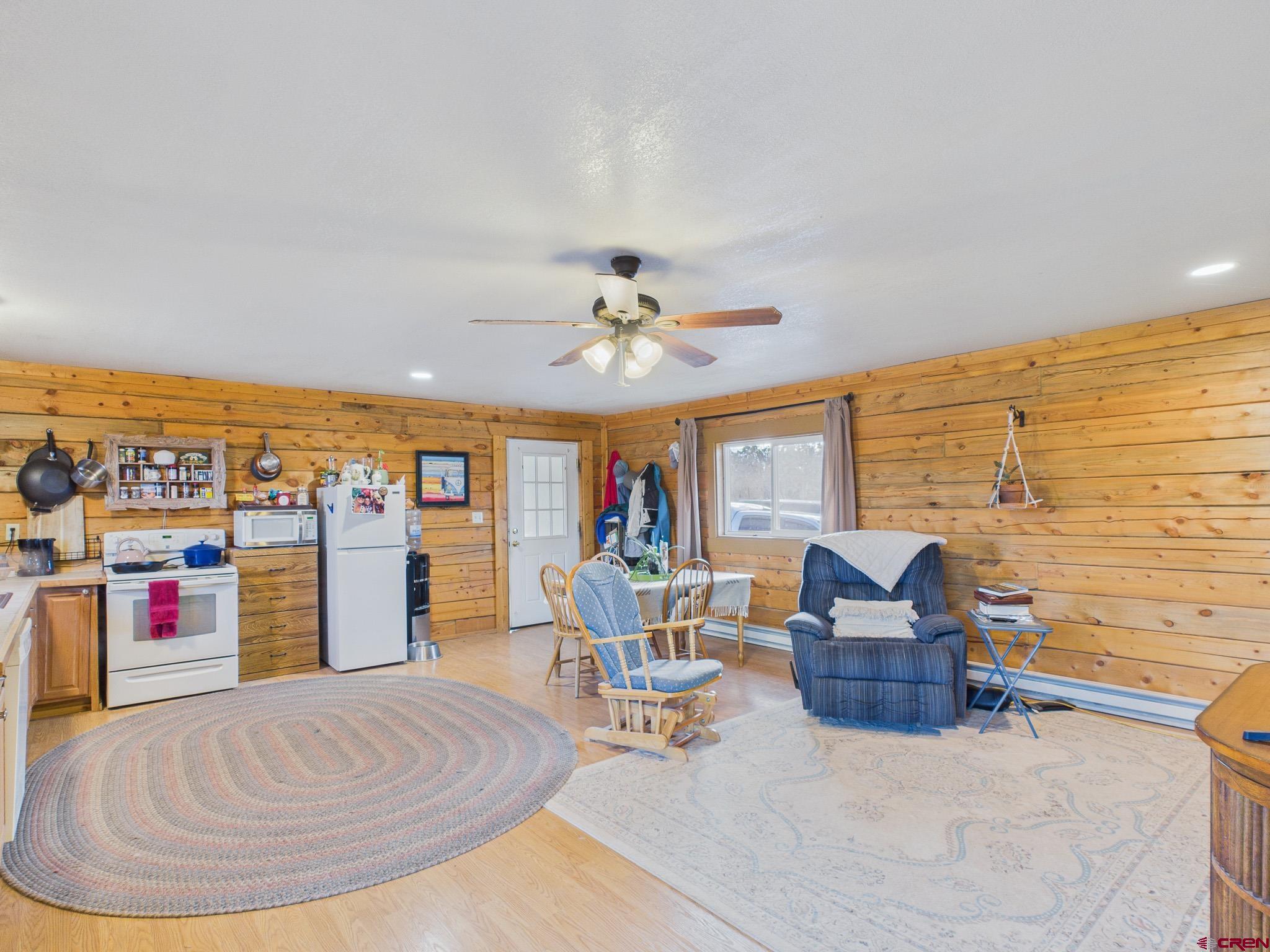 37569 Fruitland Mesa Road Crawford, CO 81415 - Photo 21 of 34 a living room with furniture and a wooden floor
