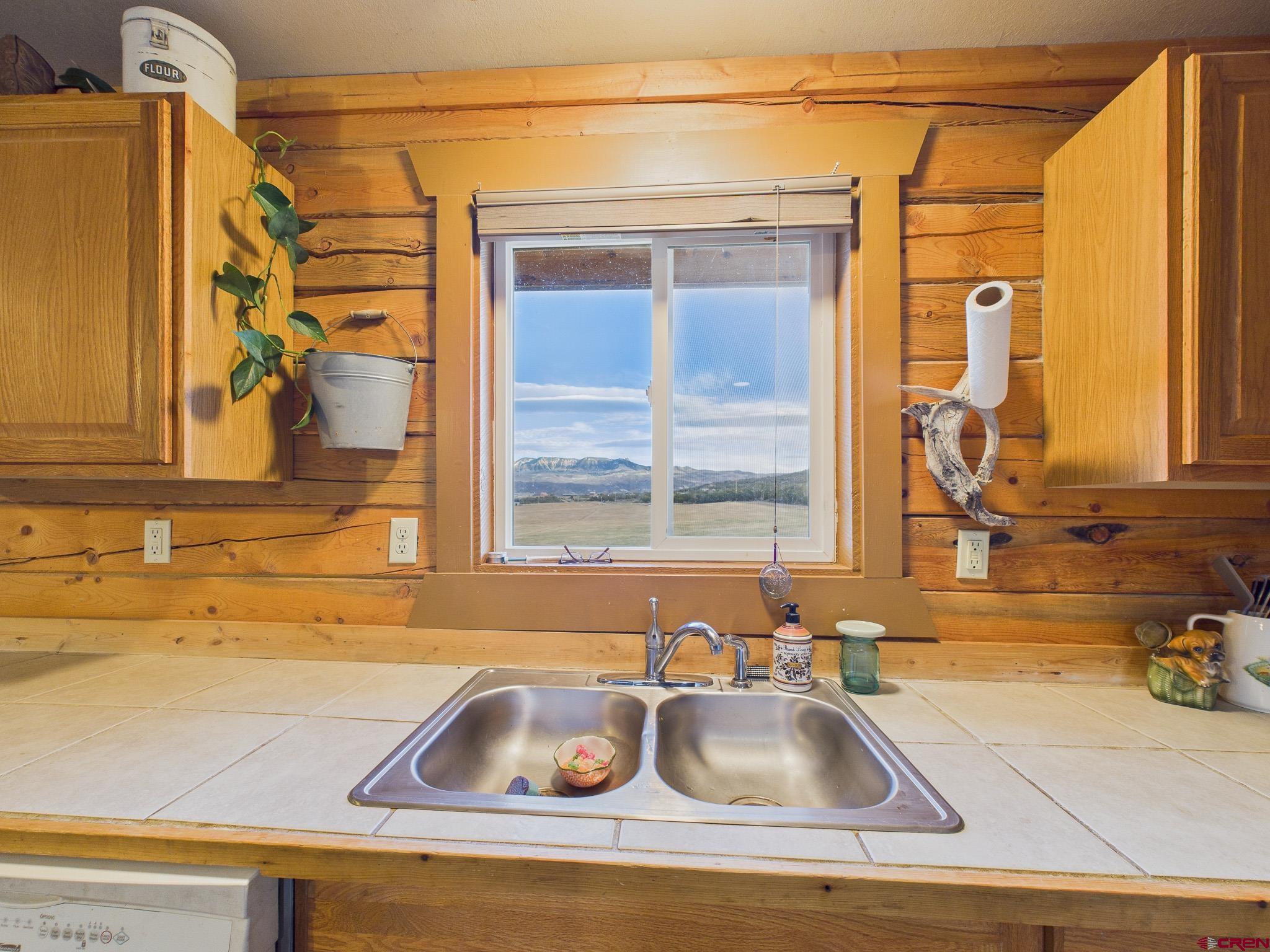 37569 Fruitland Mesa Road Crawford, CO 81415 - Photo 24 of 34 a kitchen with a sink and a window
