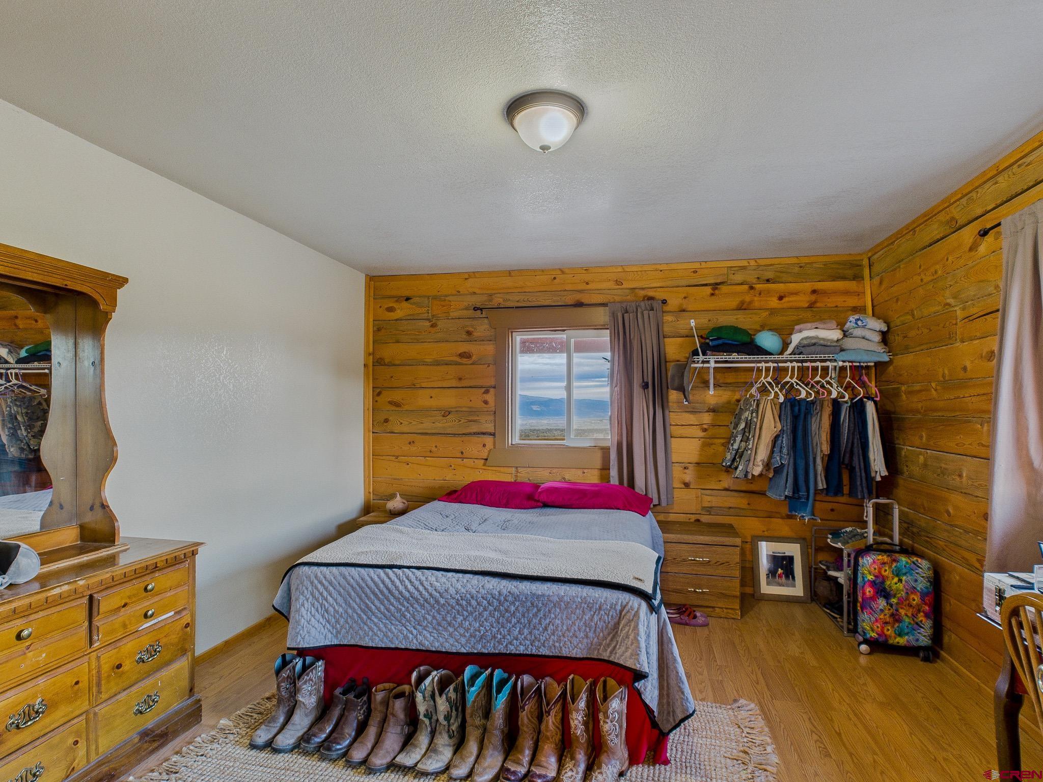 37569 Fruitland Mesa Road Crawford, CO 81415 - Photo 28 of 34 a bedroom with a bed and a closet