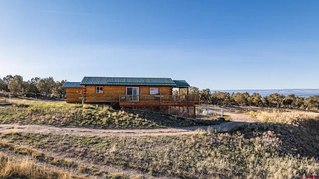 a view of a house with a yard and sitting area