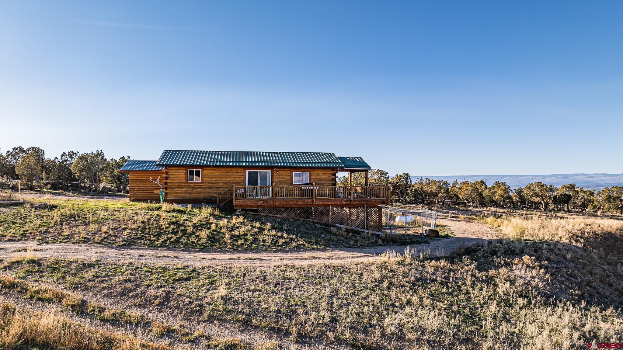 37569 Fruitland Mesa Road Crawford, CO 81415 - Photo 4 of 34 a view of a house with a yard and sitting area