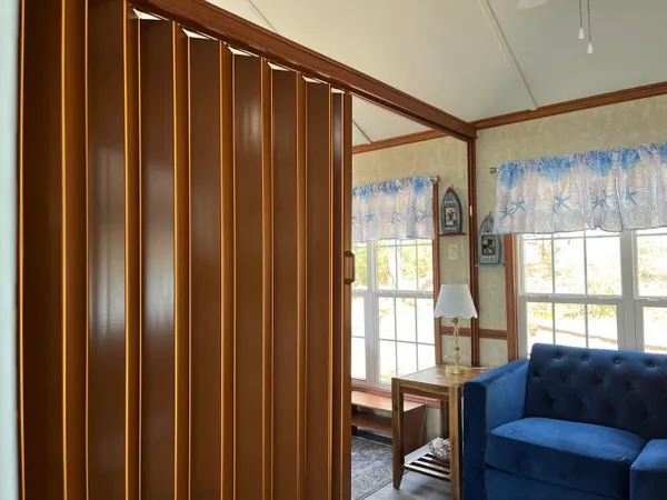 a view of a balcony with wooden floor and fence