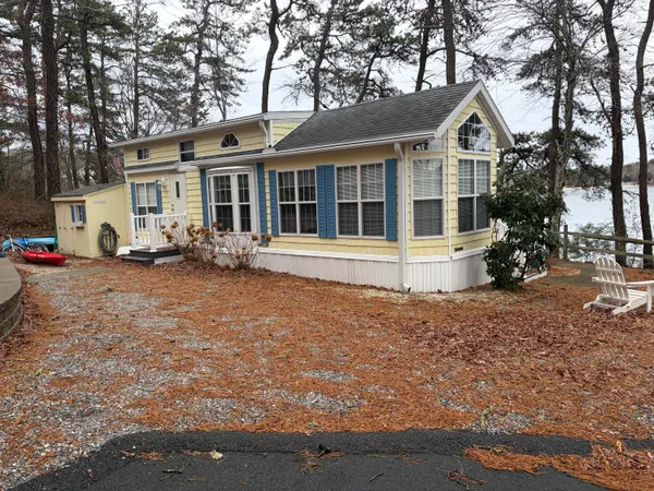 a front view of a house with garden space and sitting area