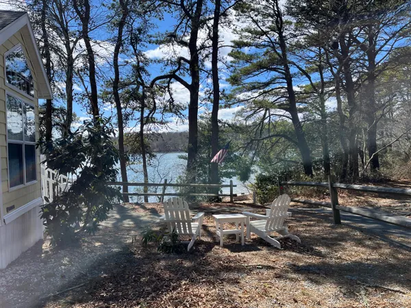 a view of a wooden house with a small yard