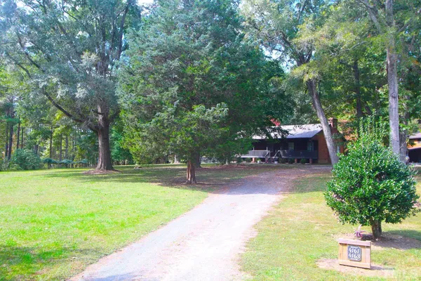 a view of a backyard with swimming pool