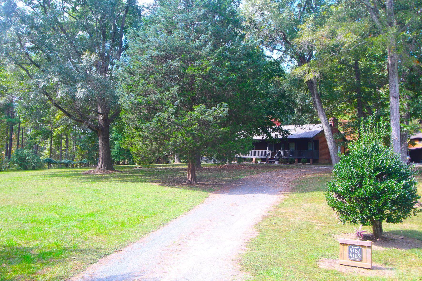 4161 Range Road Stem, NC 27581 - Photo 1 of 43 a view of a backyard with swimming pool