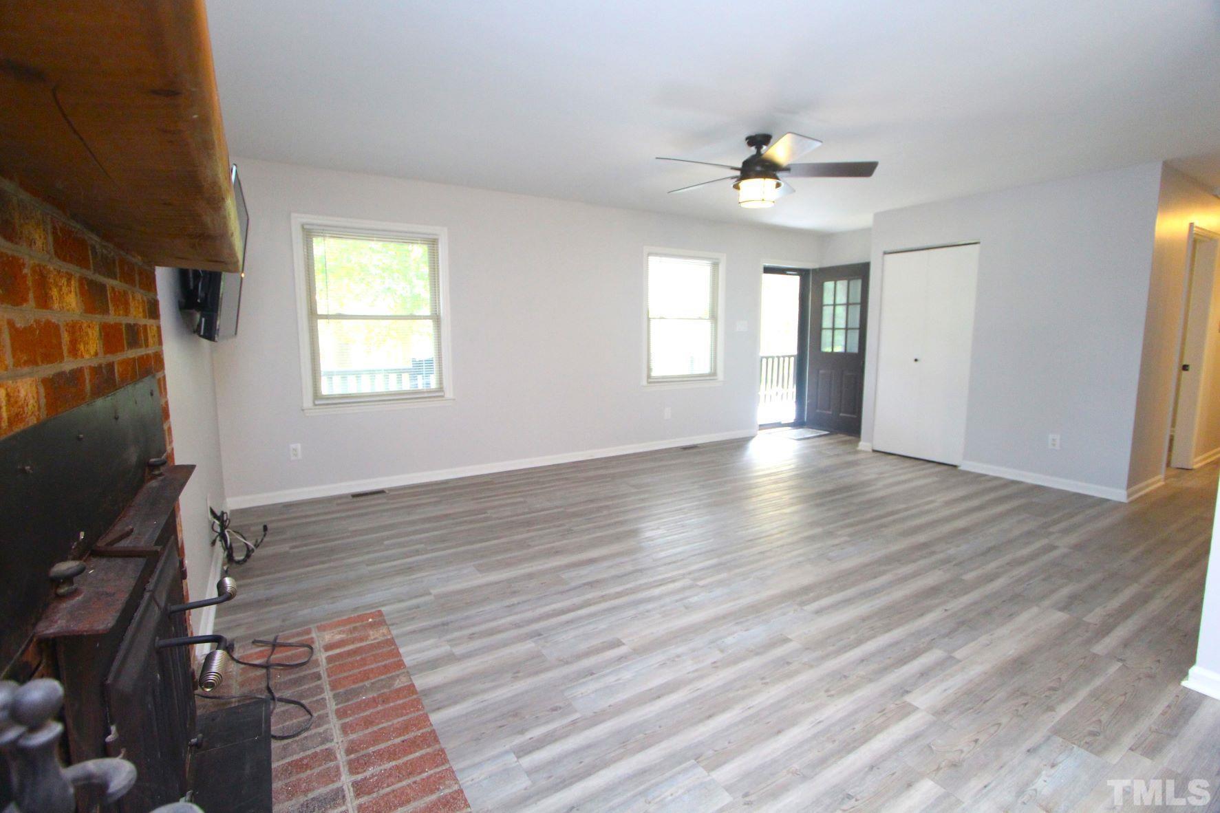 4161 Range Road Stem, NC 27581 - Photo 12 of 43 a view of an empty room with wooden floor and a window