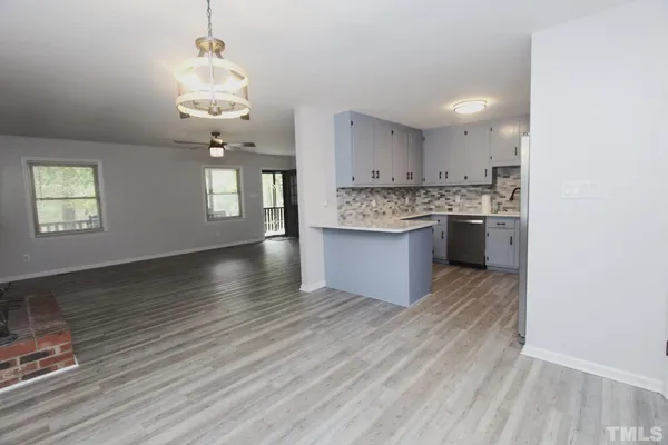a view of kitchen and sink with wooden floor