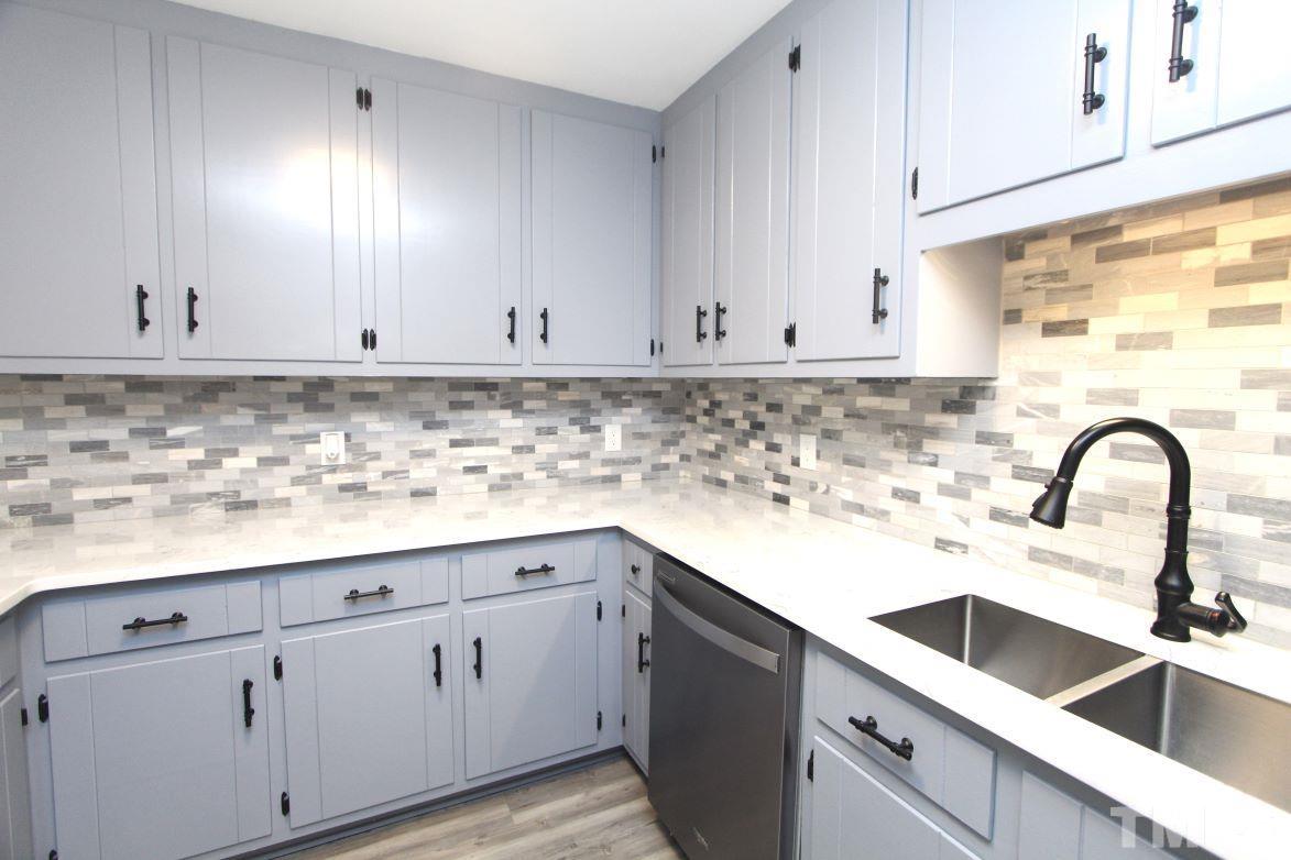 4161 Range Road Stem, NC 27581 - Photo 15 of 43 a kitchen with white cabinets and a sink