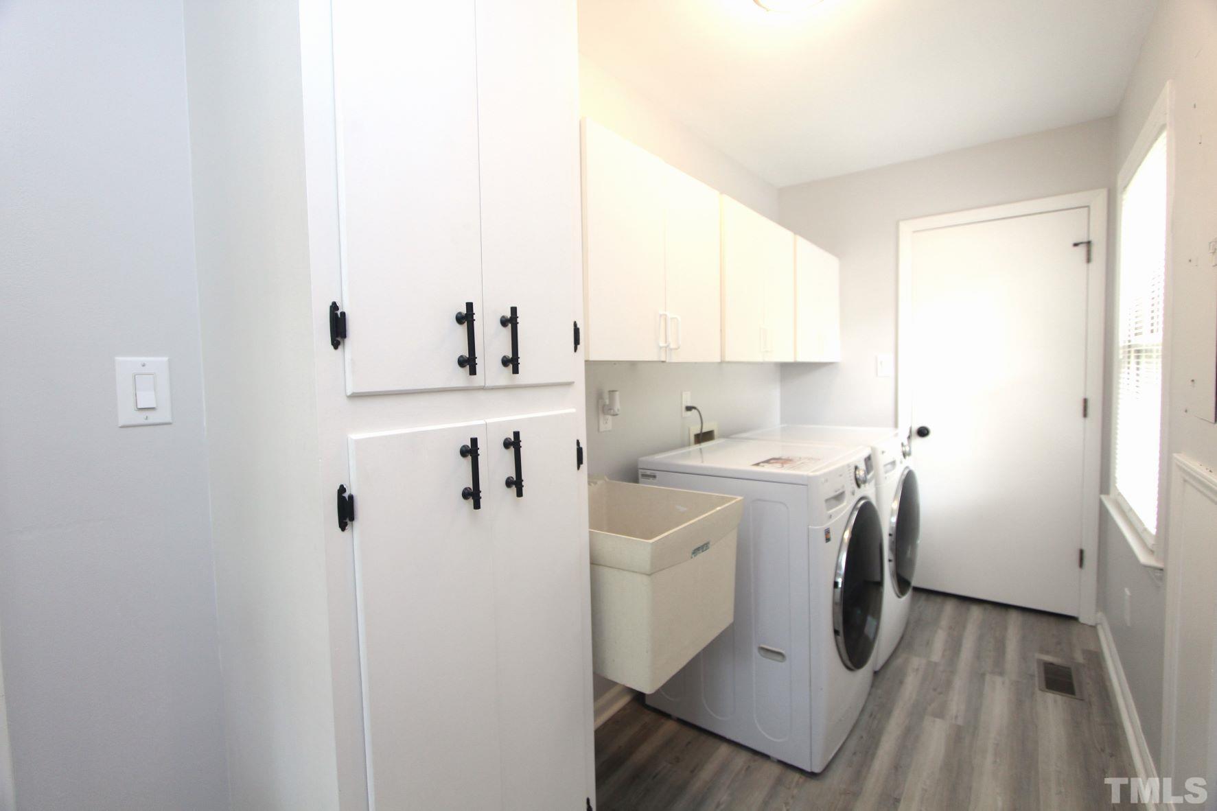 4161 Range Road Stem, NC 27581 - Photo 19 of 43 a utility room with cabinets washer and dryer