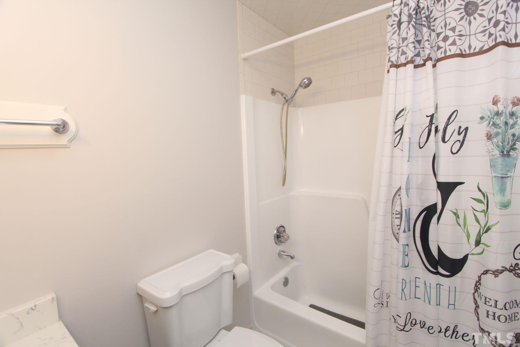 4161 Range Road Stem, NC 27581 - Photo 22 of 43 a bathroom with a toilet and a shower