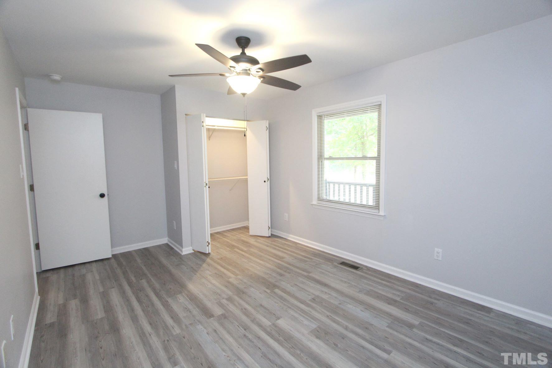 4161 Range Road Stem, NC 27581 - Photo 24 of 43 a view of an empty room with wooden floor and a window