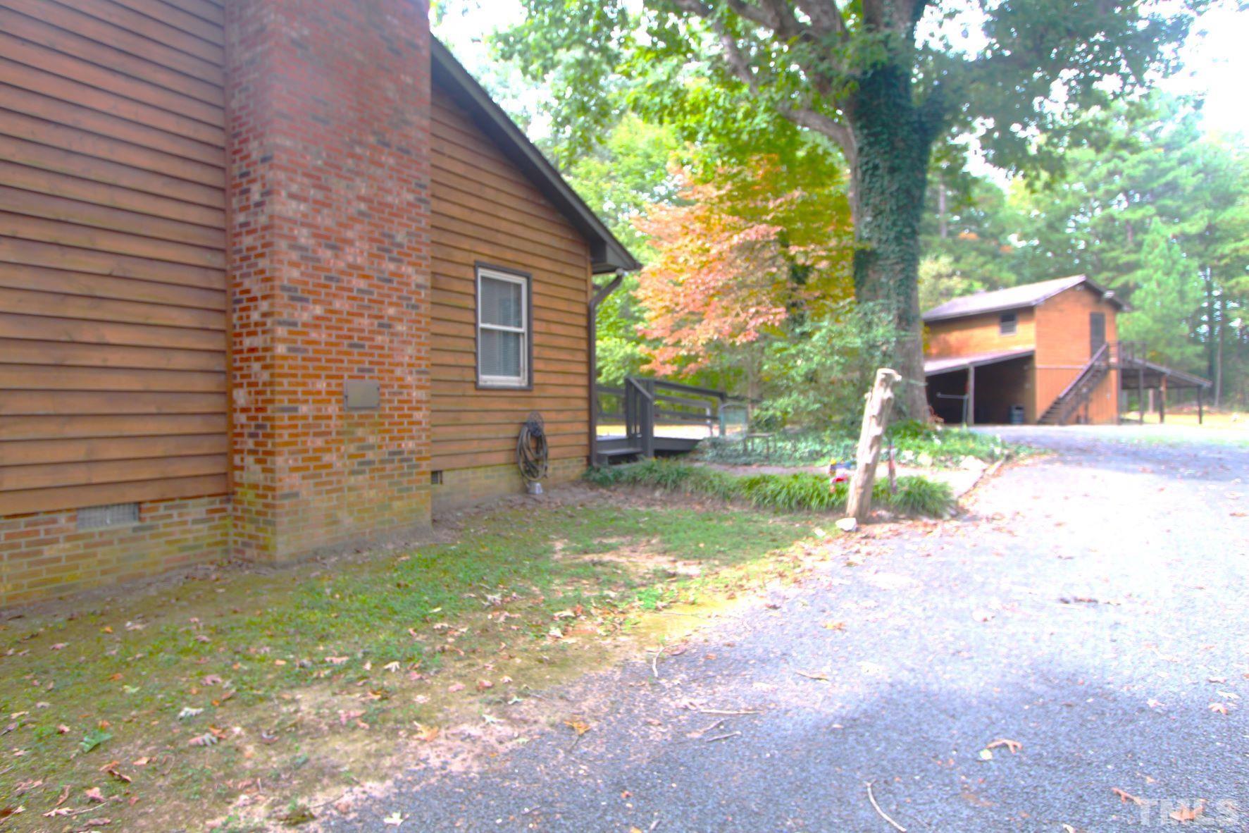 4161 Range Road Stem, NC 27581 - Photo 30 of 43 a view of a backyard with a small cabin