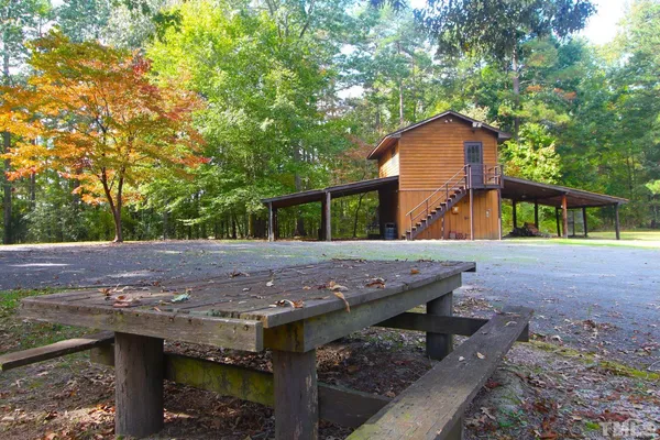 a view of house with backyard and trees
