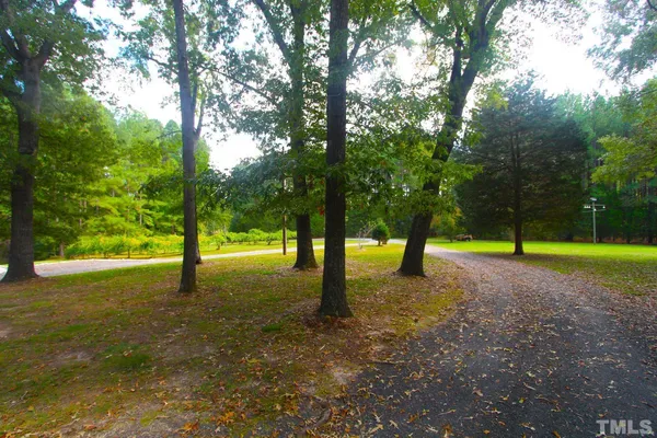 a view of a house with a yard and entertaining space