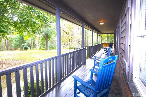 a view of balcony with wooden floor and outdoor seating