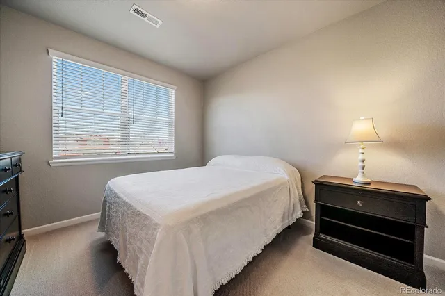 a bed room with a bed and a lamp