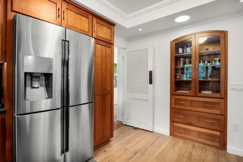 a metallic refrigerator freezer sitting in a kitchen