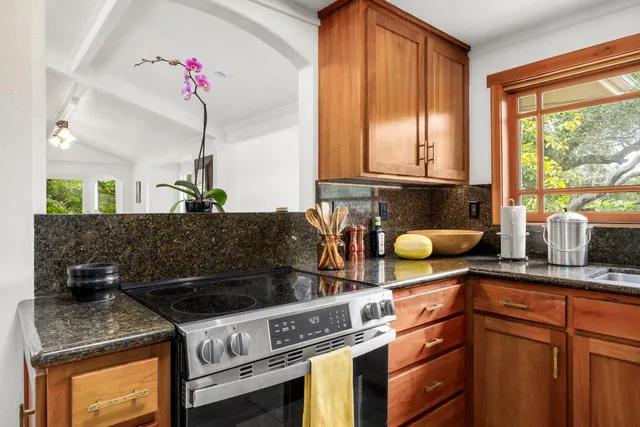 a kitchen with a sink cabinets and window