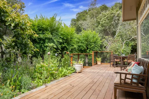 a view of a chairs and table on the wooden deck