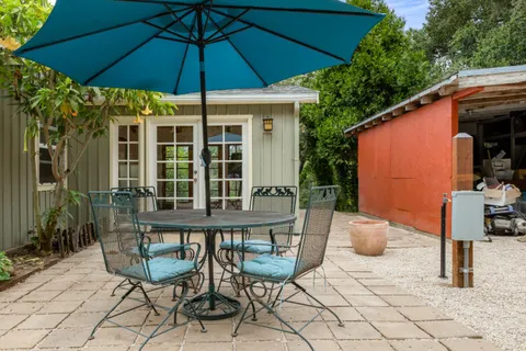 a view of a chair and table in backyard