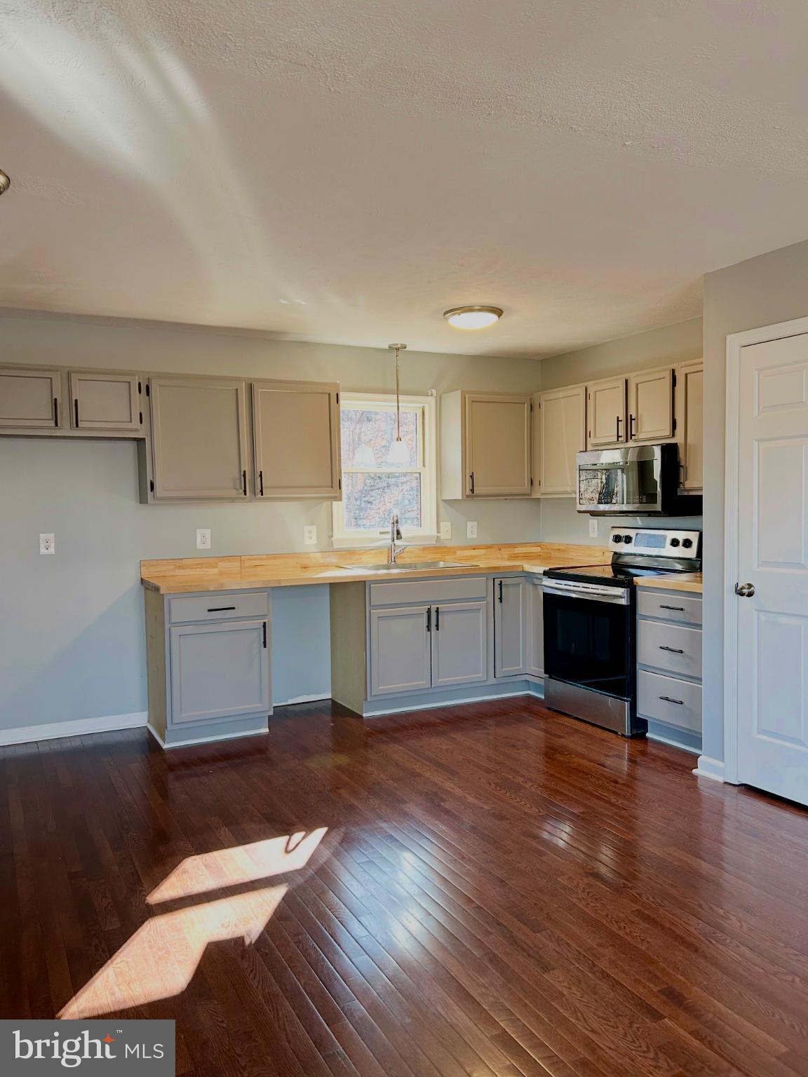 138 Parkside Road Linden, VA 22642 - Photo 17 of 38 a kitchen with a sink cabinets and wooden floor