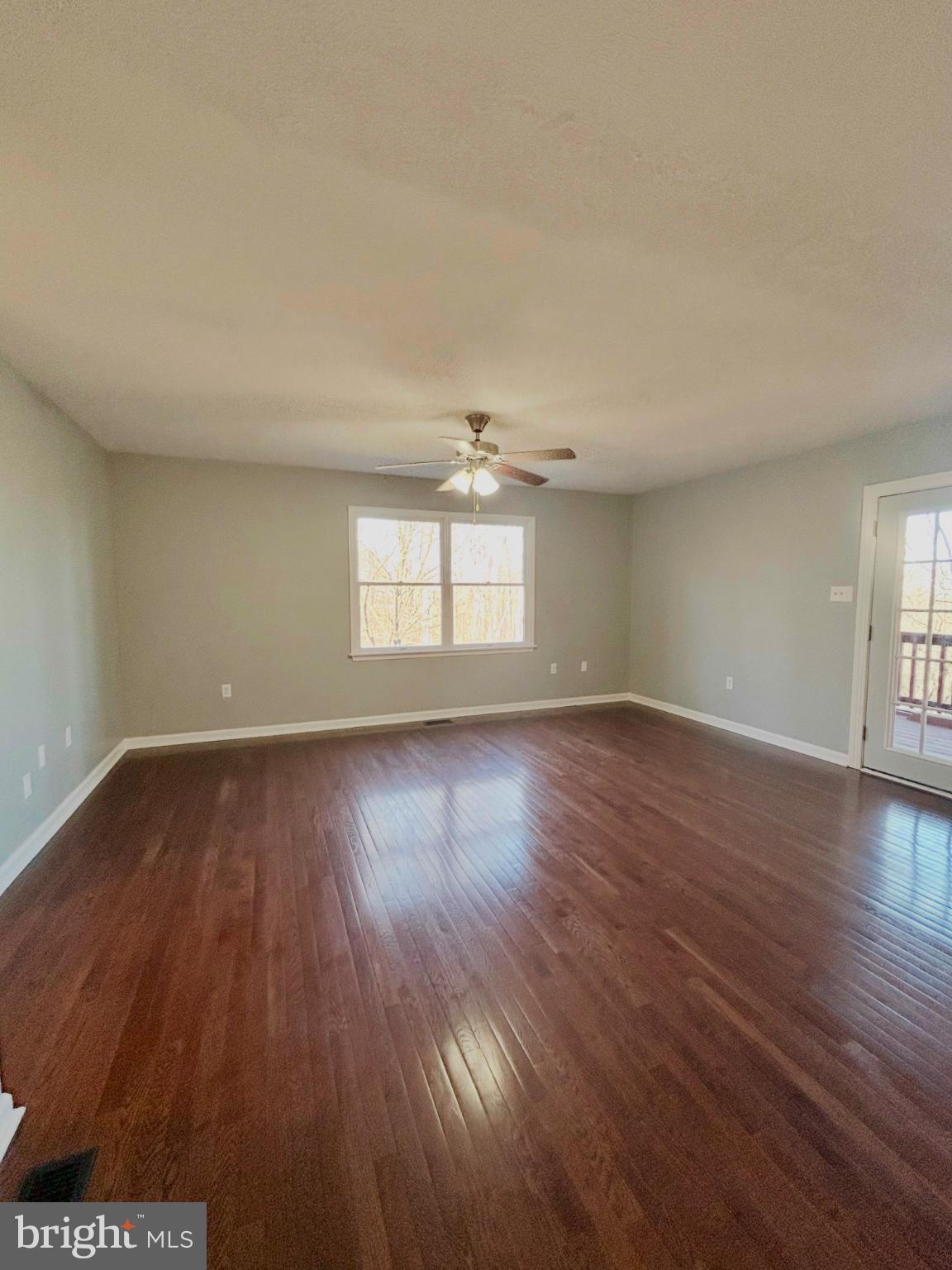 138 Parkside Road Linden, VA 22642 - Photo 19 of 38 an empty room with wooden floor and windows